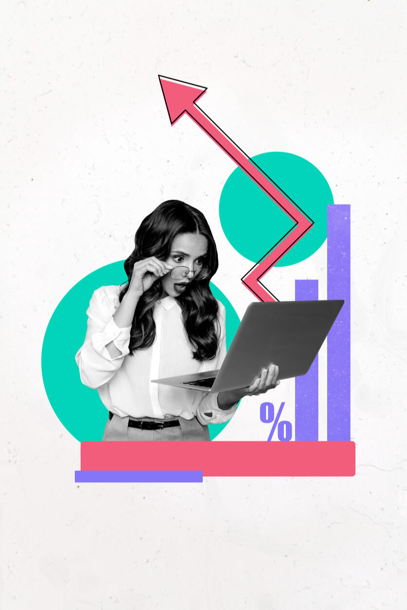 Surprised businesswoman looking at laptop with growth chart and arrow, representing unrealised lead value.